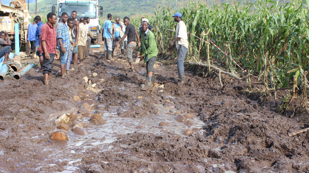 Men work to repair a damaged road in the Mulanje District of Malawi in the aftermath of Cyclone Freddy.